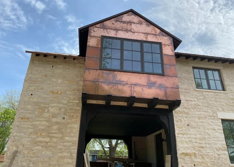 Copper metal panel facade on a stone building for Skylight Installation in East Rancho Dominguez